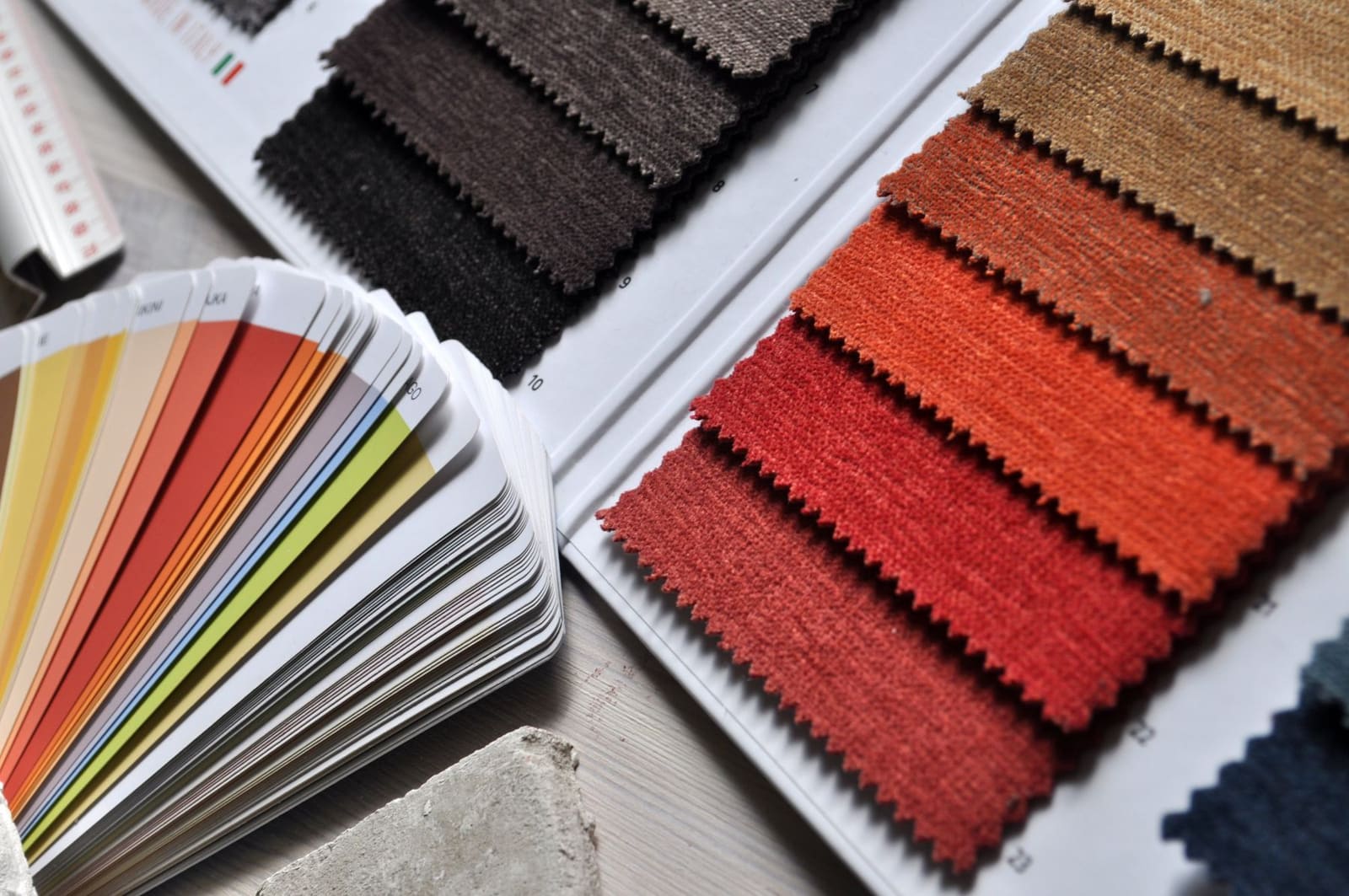 Fabric swatches and a colour fan laid out for material selection